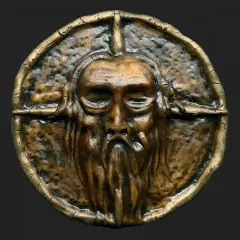 Starożytna, mosiężna maska z brodatą twarzą. Symbolizuje siłę i mądrość, przypominając, co to ród.