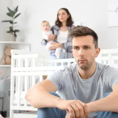 Smutny ojciec, którego narcystyczne cechy wpływają na relację z córką. Matka z dzieckiem w tle.