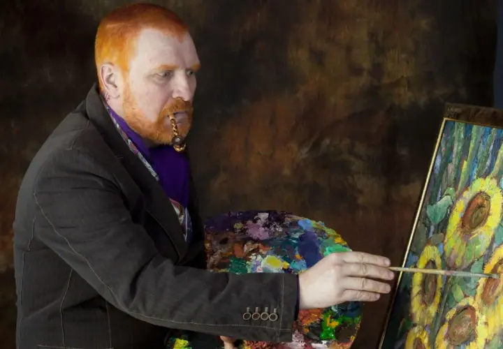 Mężczyzna z rudą brodą i fajką w ustach, malujący słoneczniki. Ciekawe van gogh ciekawostki o jego życiu i sztuce.